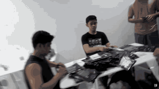 a man sitting at a table with a shirt that says rock