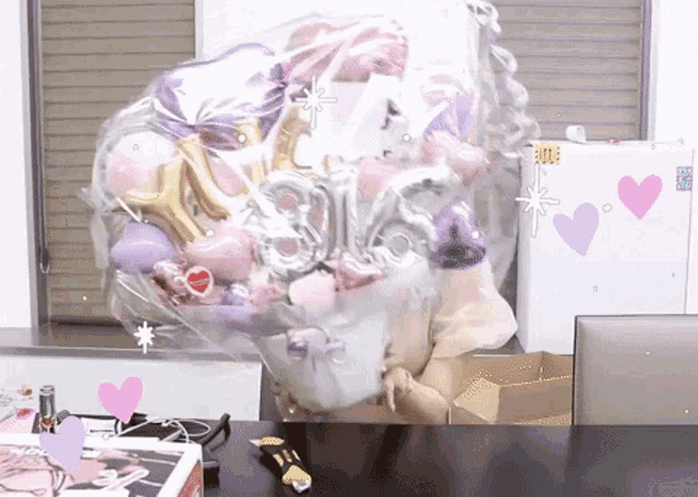 a bunch of pink and purple balloons with the number 16 on them are wrapped in plastic