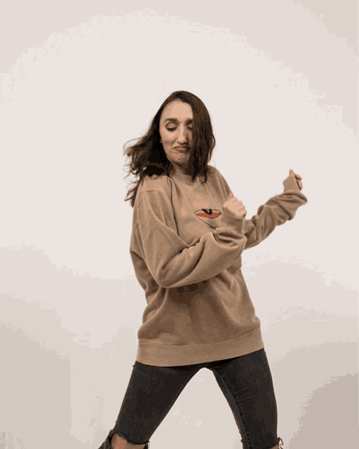a woman wearing a brown sweatshirt with a bowl of soup on it