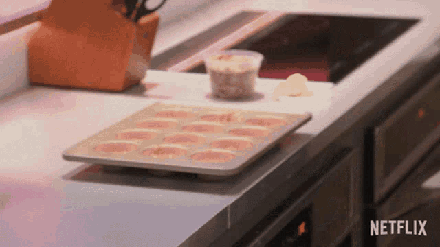 a kitchen counter with a tray of food and a netflix logo