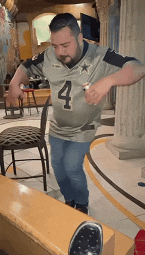 a man wearing a jersey with the number four on it