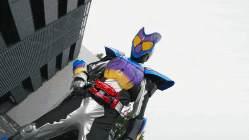 a person in a purple and blue costume with a red belt is standing in front of a building