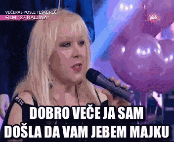 a woman singing into a microphone with the words dobro vece ja sam