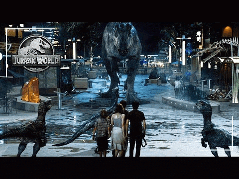 a group of people are standing in front of a jurassic world logo