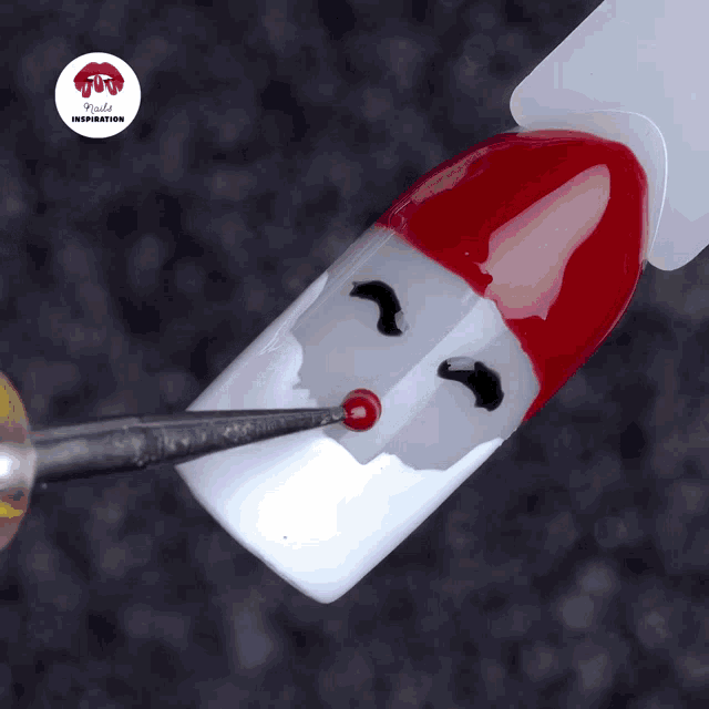a close up of a nail with a santa claus face on it