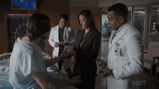 a group of doctors are talking to a patient in a hospital room with ctv written on the bottom of the screen