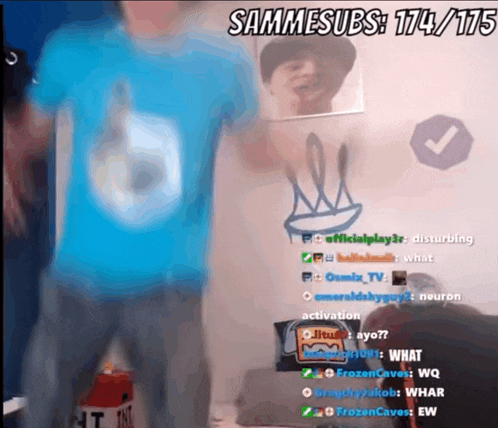 a man in a blue shirt is standing in front of a wall that says sammsubs