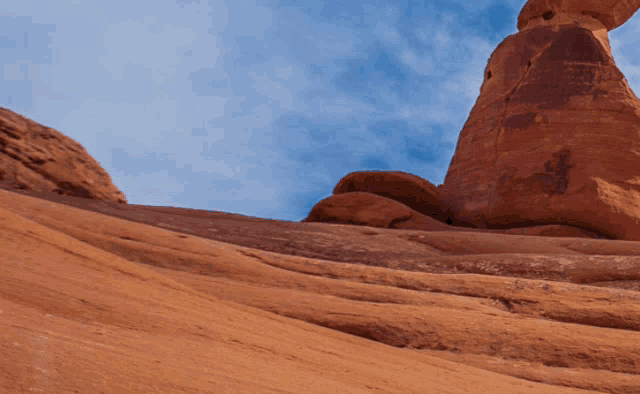 a rock formation with a blue sky behind it