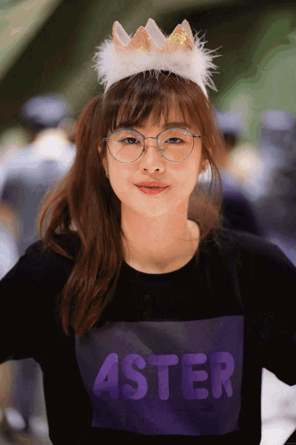 a girl wearing glasses and a headband with the word aster on it