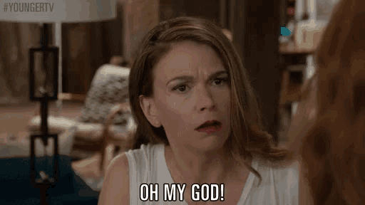 a woman is making a funny face while talking to another woman .