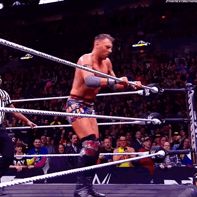a wrestler in a wrestling ring with a banner that says over on it
