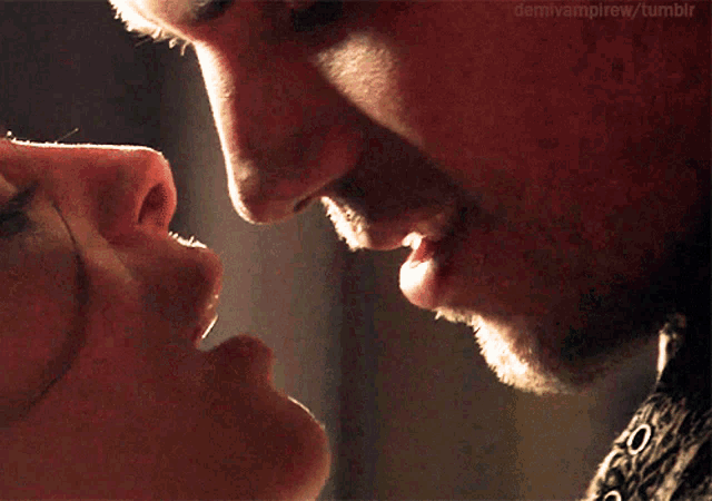 a close up of a man kissing a woman with demivampirew tumblr in the upper right corner