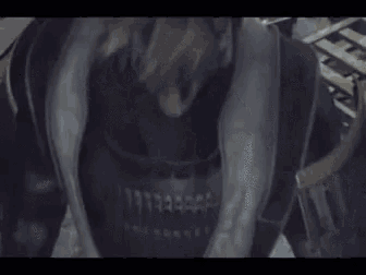 a man in a samurai costume is standing in a room with a sword .