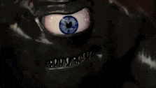 a close up of a monster 's face with a blue eye and braces .