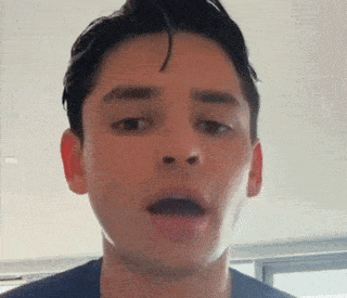 a close up of a man making a funny face with his mouth open .