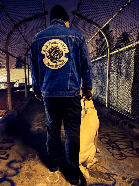 a man wearing a denim jacket that says lost honorables