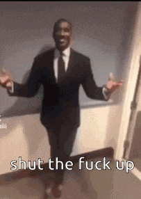 a man in a suit and tie is standing with his arms outstretched and says shut the fuck up .
