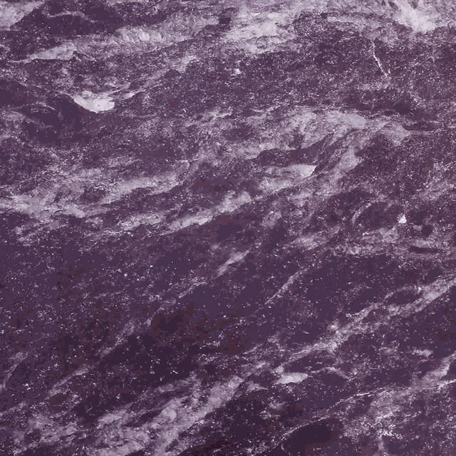 a purple marble counter top with a gray item on it that has the letter c on it