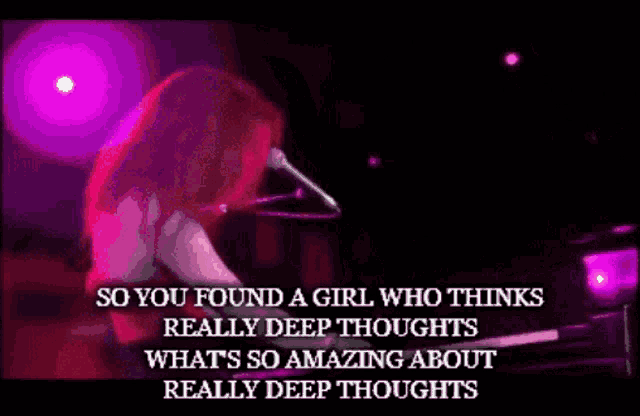 a woman singing into a microphone while playing a piano with the words so you found a girl who thinks really deep thoughts