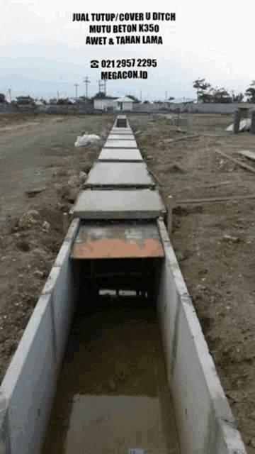 a picture of a concrete trench with a phone number on the bottom of it