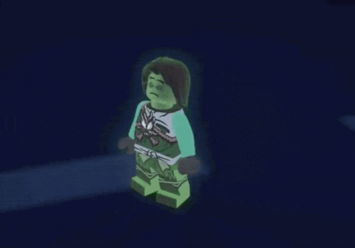 a person is standing in a dark room with a green glow coming out of their body .