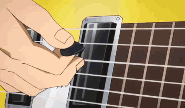 a person is playing a guitar with a pick in their hand