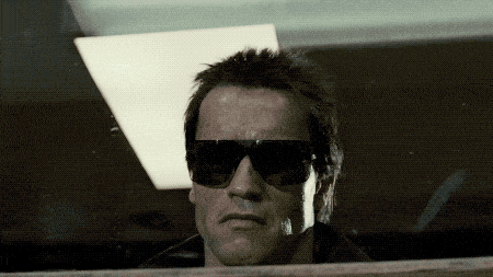 arnold schwarzenegger is wearing sunglasses and looking at the camera