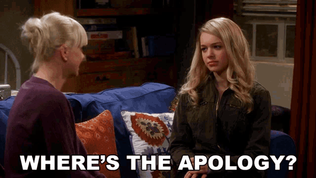 two women are sitting on a couch with the words where 's the apology