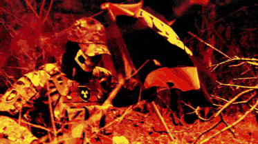 a soldier holding a red flag with a skull on it