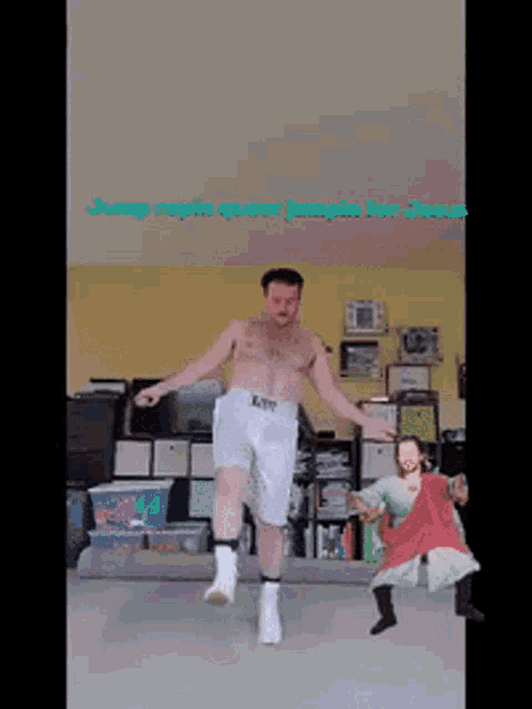 a shirtless man in white shorts is jumping in a room