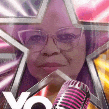 a woman with glasses is holding a pink microphone