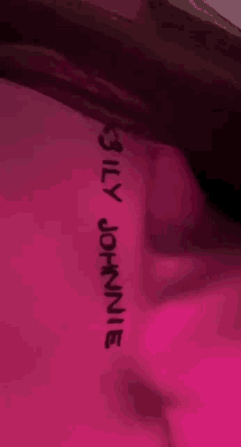 a close up of a person 's back with the name billy johnnie written on it
