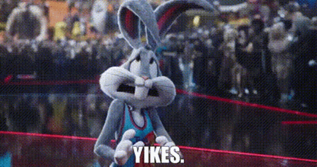 bugs bunny from space jam a new legacy is standing in a boxing ring with a crowd behind him .