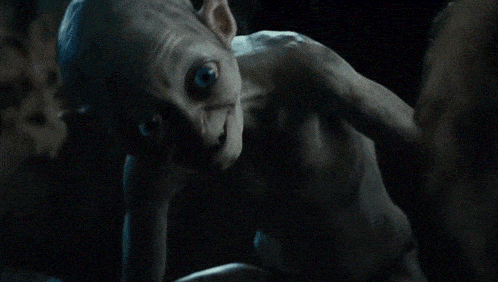 a man without a shirt is holding something in his hand in the dark