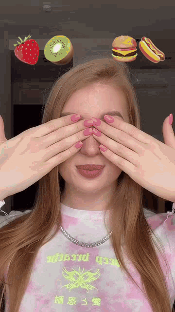 a woman covering her eyes with her hands while wearing a shirt that says ' aboard ' on it