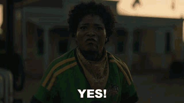 a woman wearing a green and yellow jersey that says yes