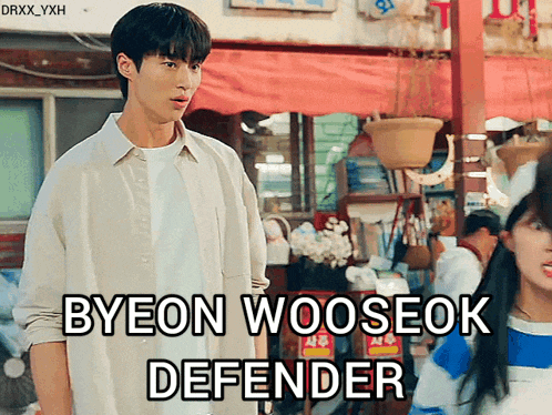 a man standing in front of a woman with the words byeon wooseok defender written below him