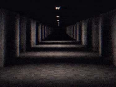 a dark hallway with a light at the end of it