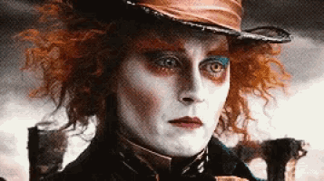 the mad hatter from alice in wonderland is wearing a hat and holding a sword .