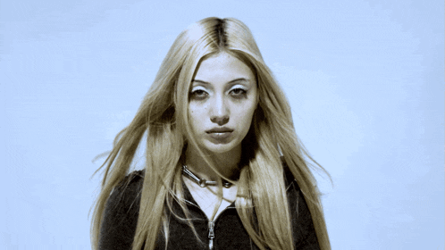 a woman with long blonde hair wearing a choker necklace