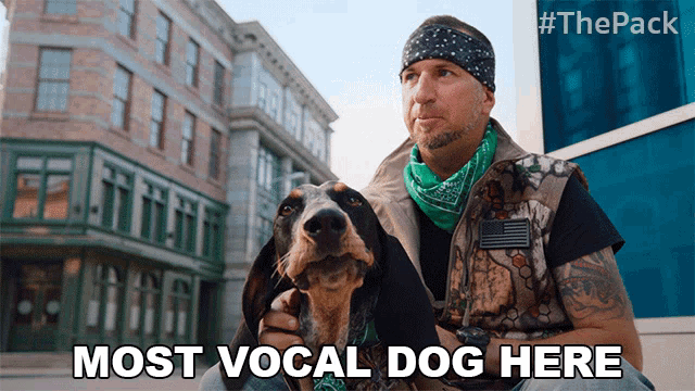 a man sitting next to a dog with the words most vocal dog here below him