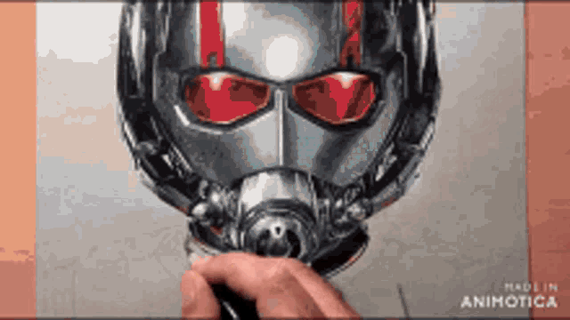 a person is drawing a picture of an ant man