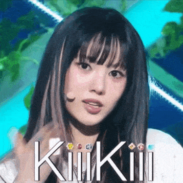 a close up of a woman 's face with the word kiikii written on the bottom