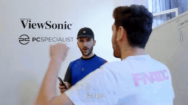 two men are standing in front of a white board with viewsonic written on it .