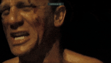 a close up of a man 's face with a to end full screen press icon above it