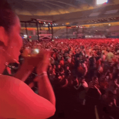 a woman is standing in front of a crowd of people