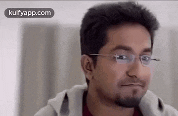 a man with glasses is making a funny face .