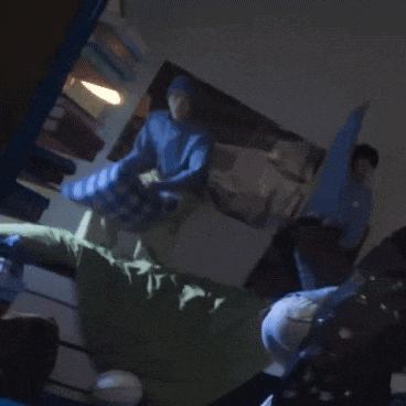 a man in a blue shirt and white pants is dancing