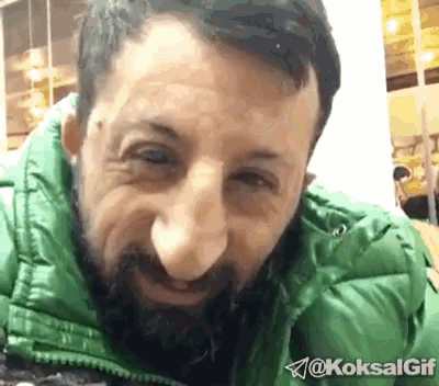 a man with a beard is wearing a green jacket with the hashtag koksalgif