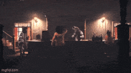 a man in a cowboy hat is riding in a horse drawn carriage in front of a bank